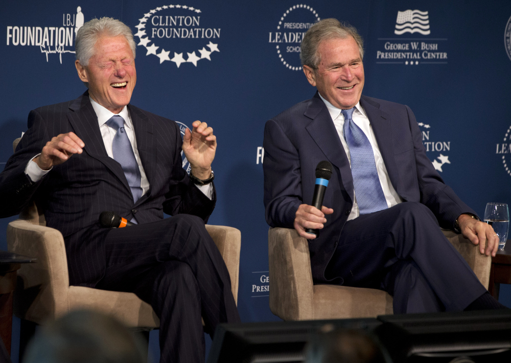 Former Presidents Bill Clinton, left, and George W. Bush trade stories at The Newseum in Washington as they launched a program to teach people about presidential leadership.
