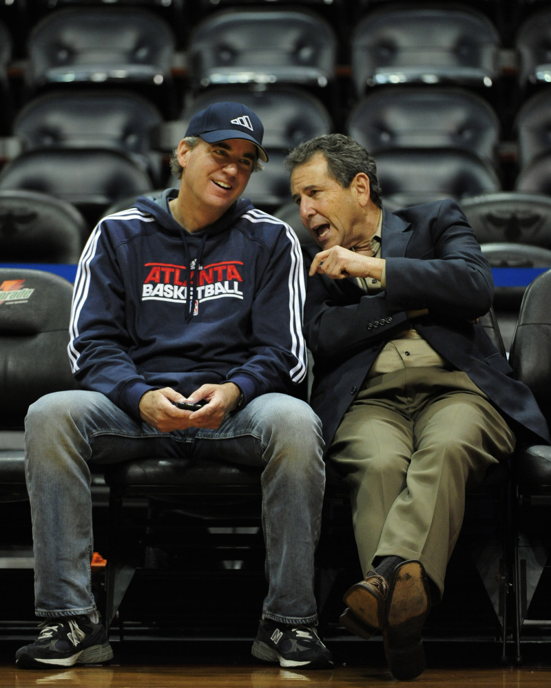 In this Dec. 22, 2011, file photo, Atlanta Hawks co-owners Michael Gearon Jr., left, and Bruce Levenson talk prior to the first half of an NBA preseason basketball game at Philips Arena in Atlanta. Hawks general manager Danny Ferry has been disciplined by CEO Steve Koonin for making racially charged comments about Luol Deng when the team pursued the free agent this year.