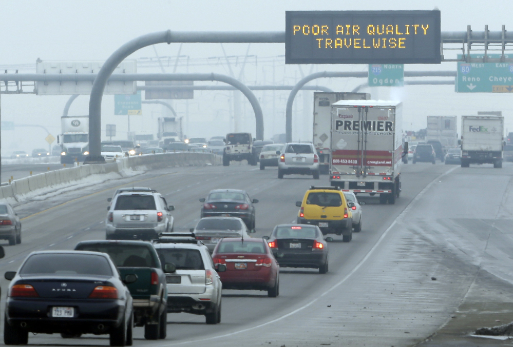 A sign warns of poor air quality over a highway in Salt Lake City. Carbon dioxide levels in the atmosphere reached a record high in 2013 as increasing levels of man-made pollution transform the planet, the U.N. weather agency said Tuesday.