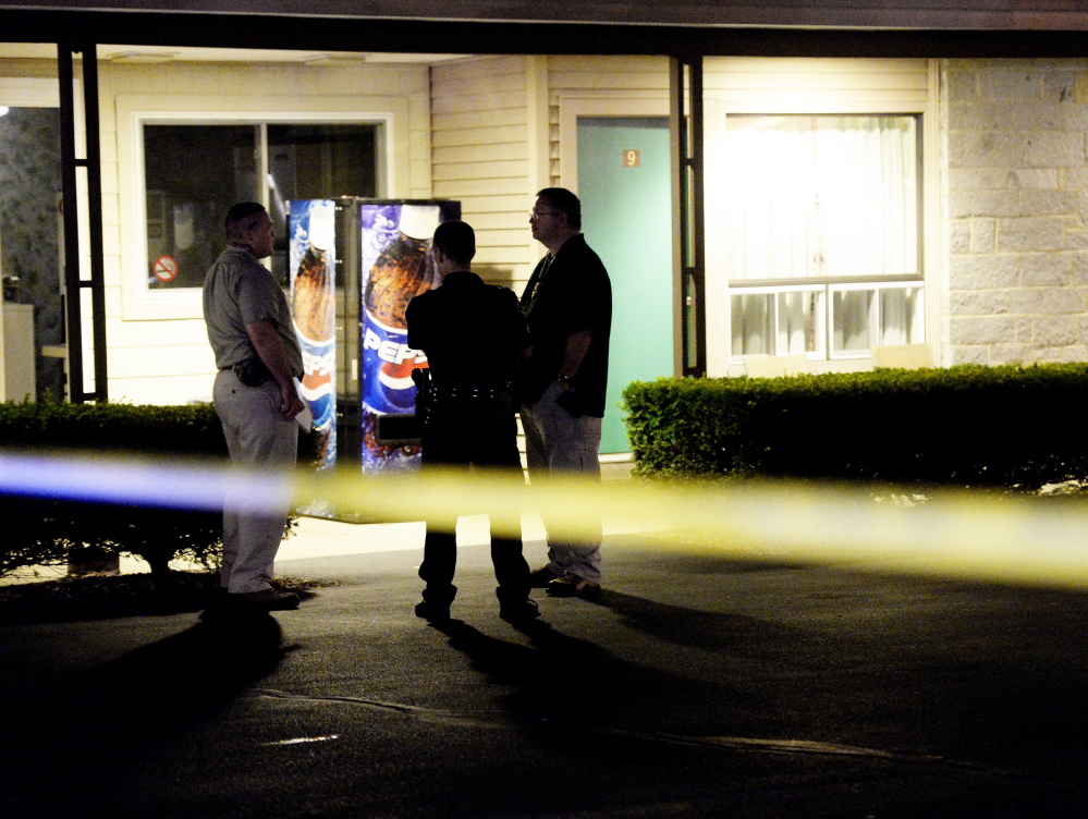 Biddeford police and a Maine State Police detective investigate the discovery of two bodies in a room at the Sleepy Hollow Motel in Biddeford on Tuesday night.