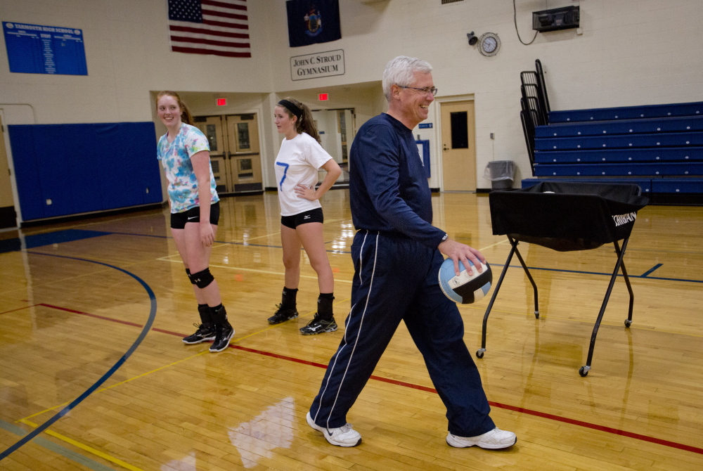 Yarmouth volleyball players Heather Clark and Makenzie Sheehan look toward coach Jim Senecal, at right, during practice Monday. The Clippers hope to repeat as Class B champions. 

Gabe Souza/Staff Photographer