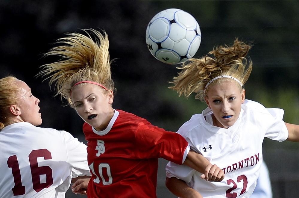 South Portland’s Callie O’Brien, middle, goes up for the ball between two Thornton Academy players, Katherine Gillespie, left, and Hannah McAlary in Wednesday’s girls’ soccer game at Saco. The Trojans won, 6-1.