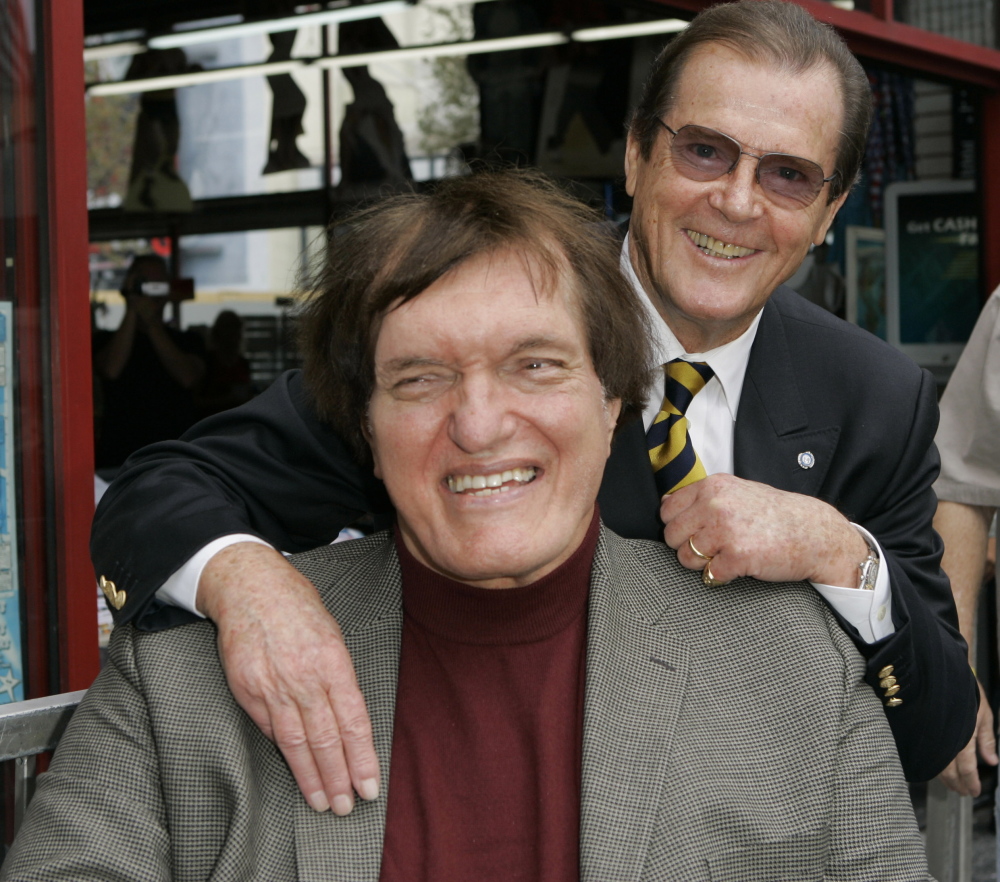 The 7-foot-2-inch actor Richard Kiel, front, who played the role of Jaws in “The Spy Who Loved Me” and “Moonraker,” is shown with James Bond actor Roger Moore in 2007.