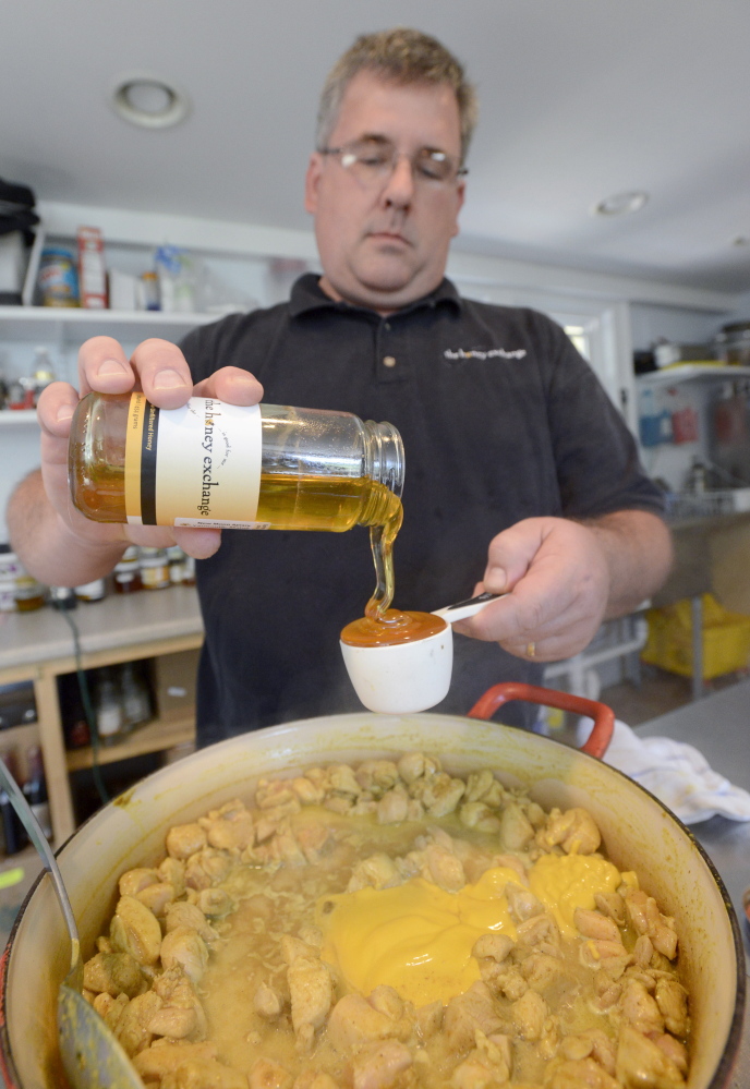 Phil Gaven adds honey as he  prepares Honeyed Curried Chicken at The Honey Exchange in Portland. John Patriquin/Staff Photographer