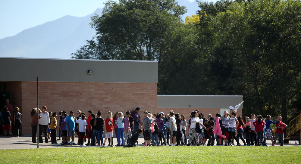 Students line up to go back inside after recess at Westbrook Elementary School in Taylorsville, Utah, on Thursday. Earlier, a teacher accidentally shot herself in the leg while alone in a faculty bathroom shortly before school started.