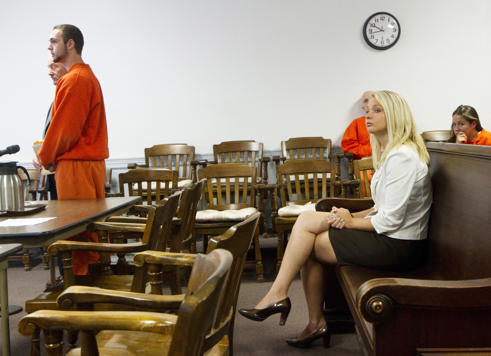 Former Southern Maine RE-entry Center guard Bret Butterfield stands before the judge at his bail hearing as his wife Emily Butterfield looks on at right, at York County Superior Court in Alfred on Friday.