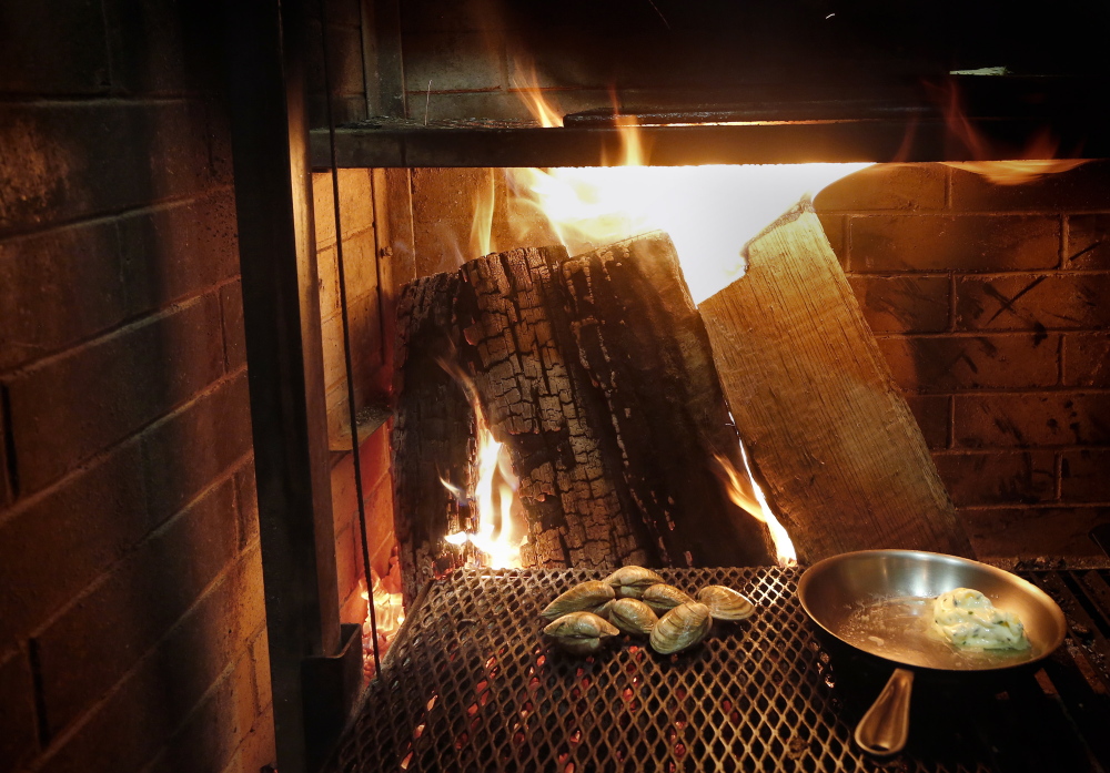 Clams roast by the fire of Lolita’s custom wood grill.