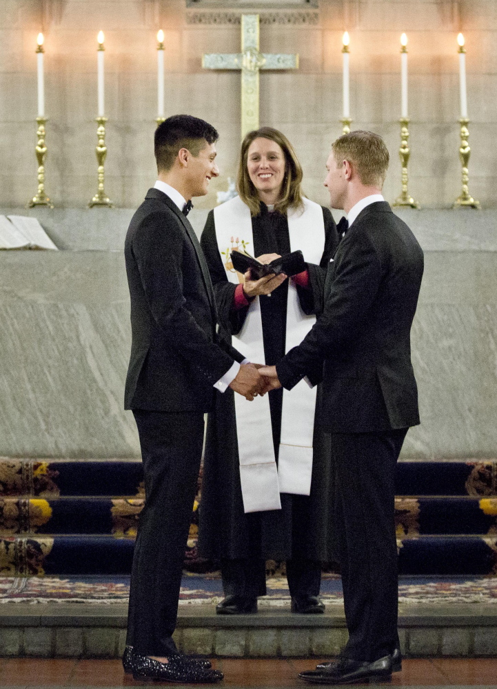 Larry Lennox-Choate, left, and Daniel Lennox-Choate are wed by Army chaplain Cynthia Lindenmeyer in New York last year. Duke University’s study found acceptance of gay members in congregations rose from 37 percent to 48 percent from 2006 to 2012.