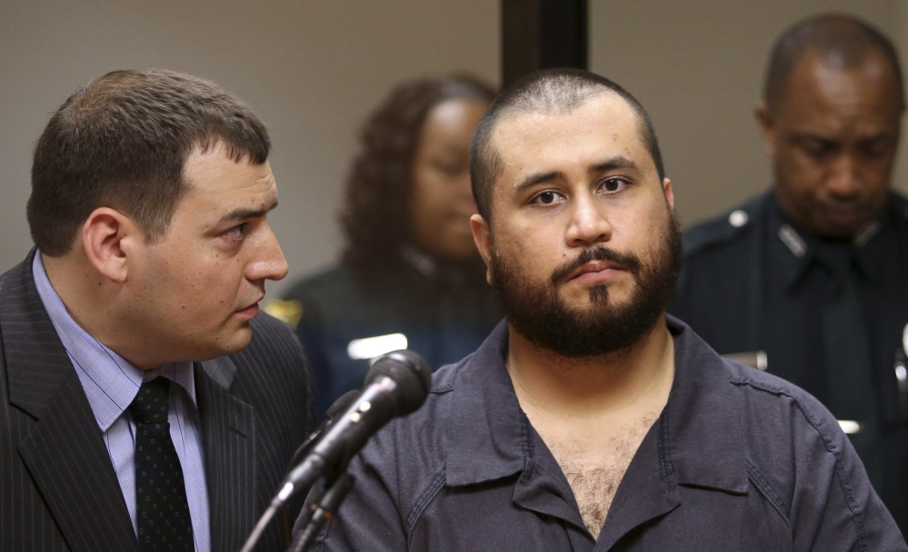 George Zimmerman, right, the gunman in the death of Trayvon Martin, listens to defense counsel Daniel Megaro during his initial court appearance in Sanford, Fla., in 2013.