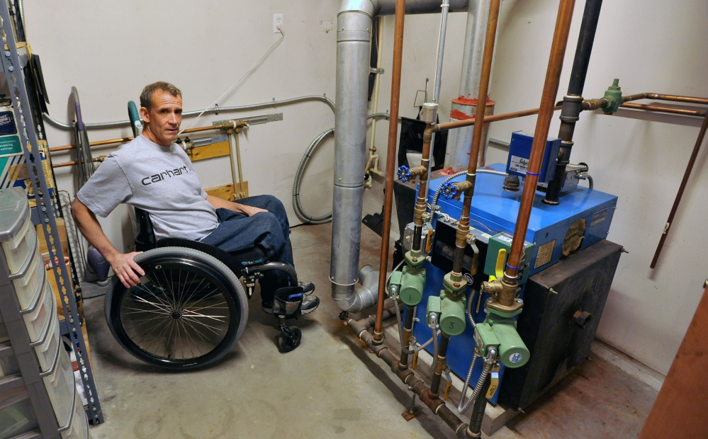 WATERVILLE, MAINE - SEPTEMBER 10, 2014. 
 Bruce Falconer, sits in by his boiler at his 7 Forest Park residence in Waterville on Wednesday, Sept. 10, 2014. Falconer has been having difficulty converting from oil to natural gas.