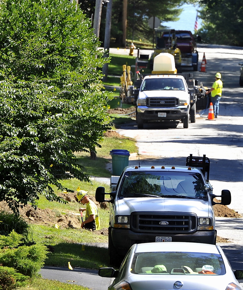 CUMBERLAND, ME - SEPTEMBER 10: A crew from Midwest Utility out of Missouri installs the distribution lines that connect the homes to the supply lines buried along Wildwood Boulevard that connect to the main 8' pipe along Route 88 in Cumberland Foreside.