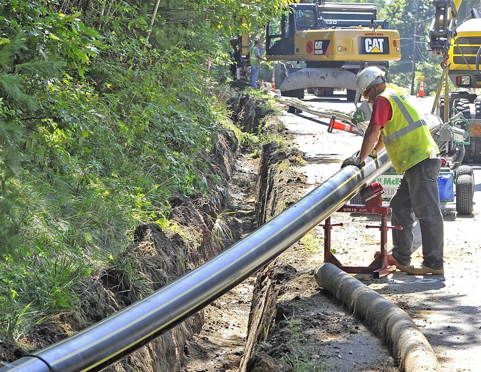 A Cianbro crew prepares to bury natural-gas pipe along Route 88 in Cumberland in early September. Summit Natural Gas of Maine is also laying pipe in Falmouth and Yarmouth.