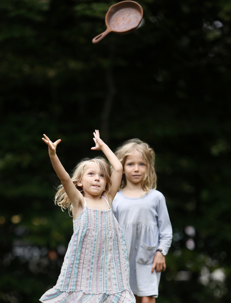 Pele Coffin, 7, of Freeport watches as her sister Piper, 4, competes in a cast-iron skillet toss at Bradbury Mountain State Park in Pownal on Saturday. A dozen people took part in the cook-off.