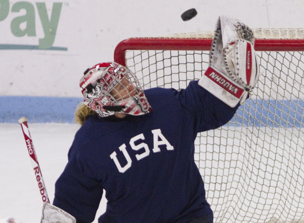 USA women’s hockey goalie Alex Rigsby makes a glove save during the team’s evaluation camp at Harold Alfond Forum at the University of New England in Biddeford.