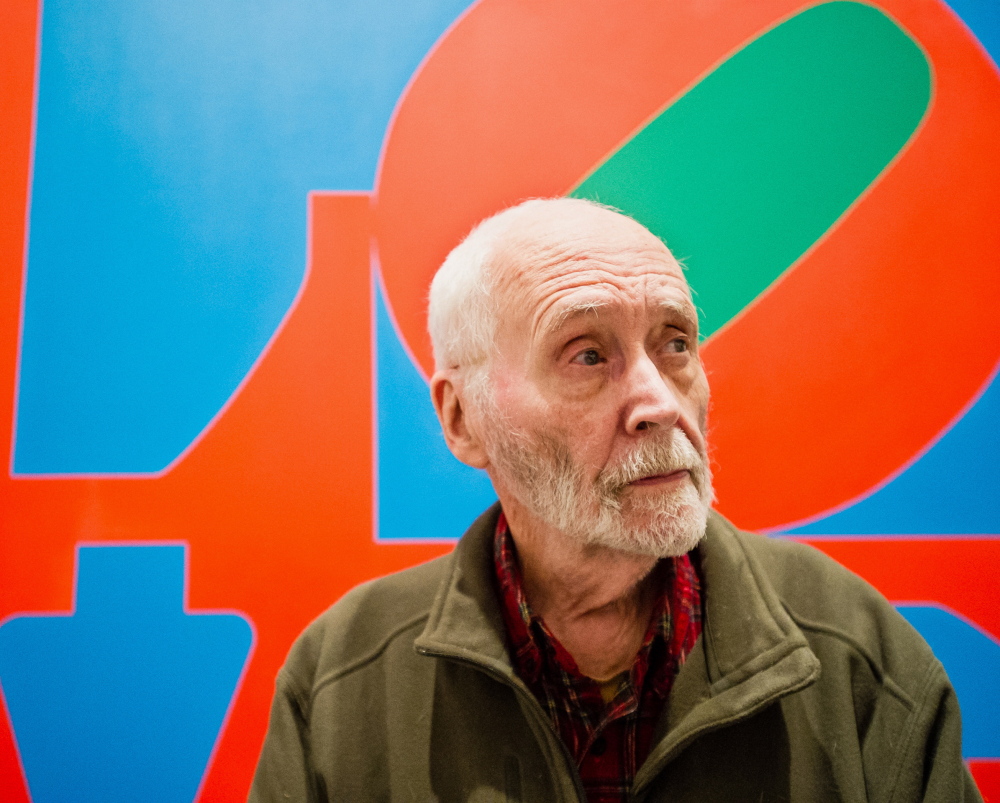 Artist Robert Indiana, known for his LOVE image, appears in front of that painting at New York’s Whitney Museum of American Art in 2013.