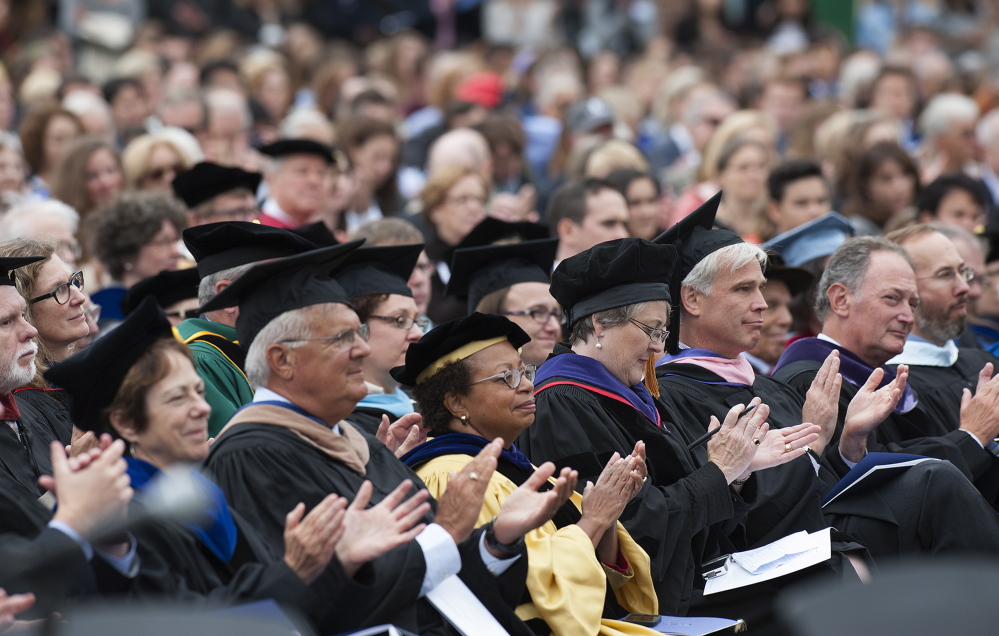 Faculty members applaud incoming Colby College President David Greene during his inauguration Saturday at the college in Waterville.