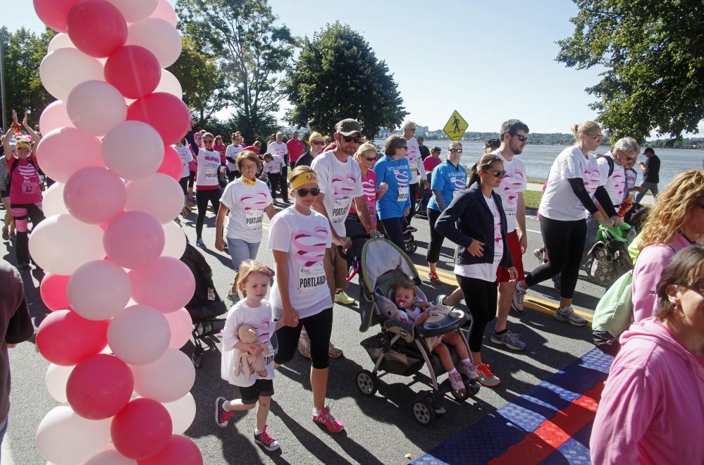 Walkers begin the annual Race for the Cure for breast cancer on Back Cove in Portland on Sunday.