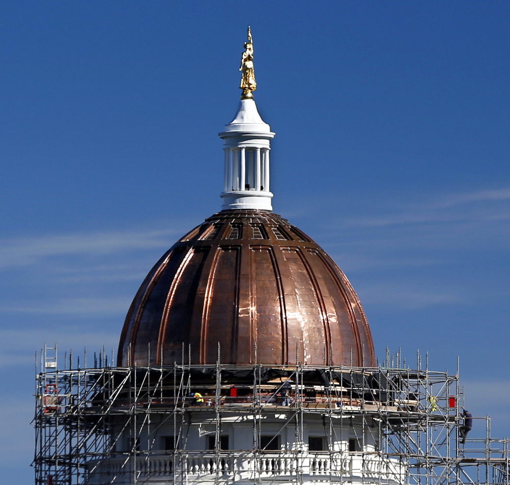 Work continues Friday on the State House dome in Augusta. Legislative leaders are deciding what to do with the 7,000 square feet of old, tarnished copper that’s been removed.