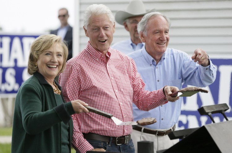 Deemed the “comeback couple” by retiring U.S. Sen. Tom Harkin, right, former Secretary of State Hillary Rodham Clinton and former President Bill Clinton grill steaks during Harkin’s annual fundraising Steak Fry in Indianola, Iowa, on Sunday.