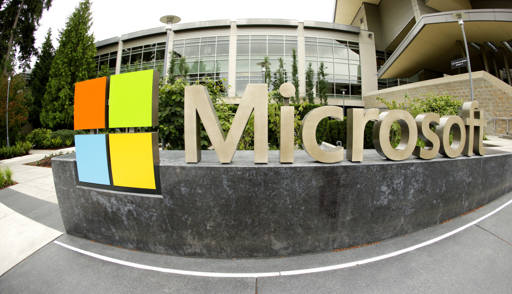 This July 3, 2014 file photo taken with a fisheye lens shows Microsoft Corp. signage outside the Microsoft Visitor Center in Redmond, Wash.