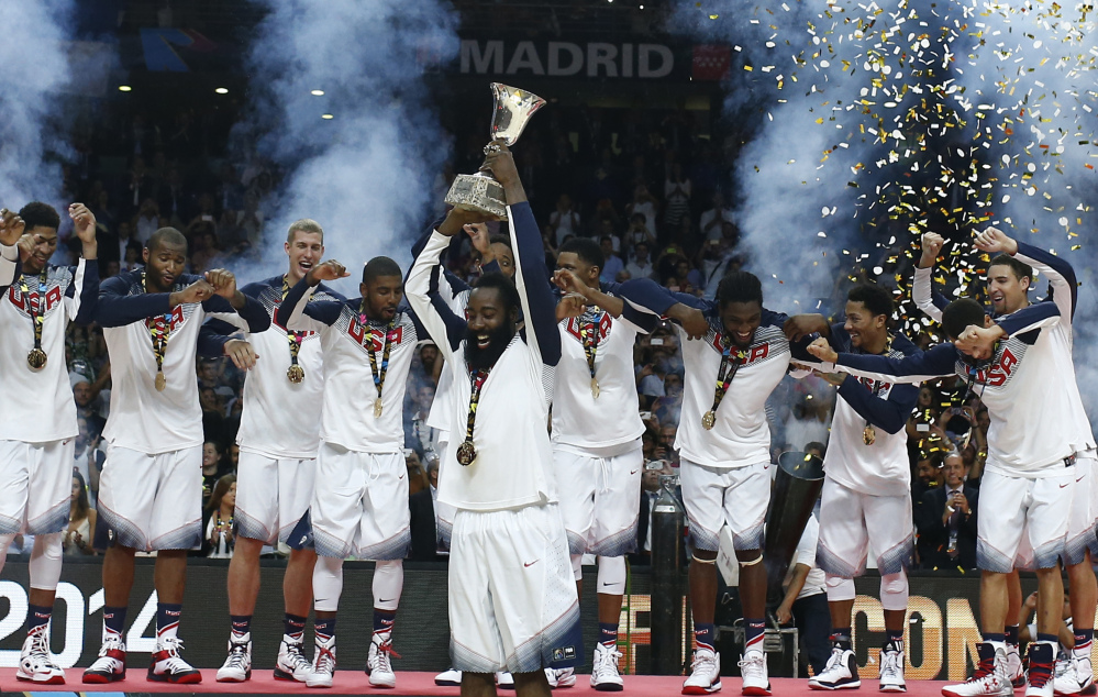 James Harden of the U.S. lifts the trophy alongside the rest of the team as they celebrate wining the final of the World Cup Basketball match with Serbia in Madrid, Spain, on Sunday. 
The Associated Press