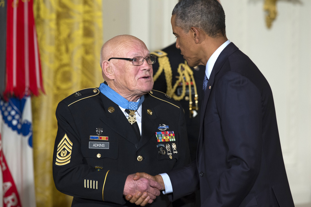 President Obama shakes hands with retired Army Command Sgt. Maj. Bennie G. Adkins after presenting him with the Medal of Honor at the White House on Monday.