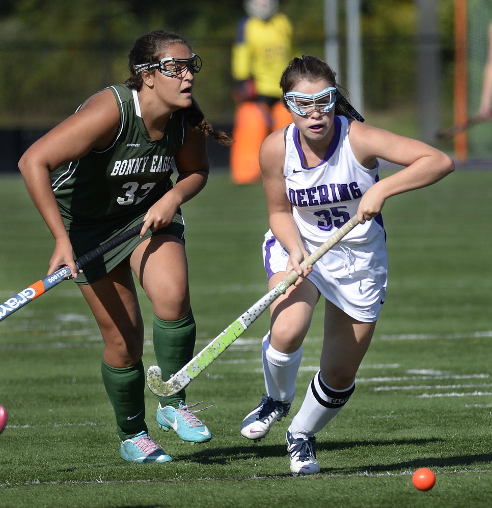 Deering’s Kerry Wells and Bonny Eagle’s Marissa Jeffords chase the ball during their game Monday. The Rams scored four times in the second half to beat the Scots, 4-0.