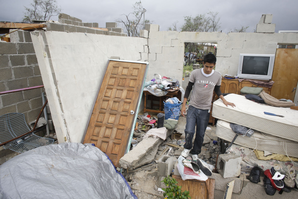 Raimundo Diaz, 17, walks inside what used to be a bedroom Monday, after his family’s house in Los Cabos, Mexico, was destroyed by Hurricane Odile.