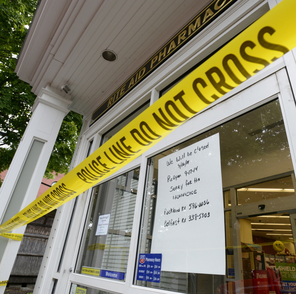 Police tape blocks an entrance to a Rite Aid pharmacy in Camden on Tuesday and a sign in the window tells customers that the store will reopen Wednesday.