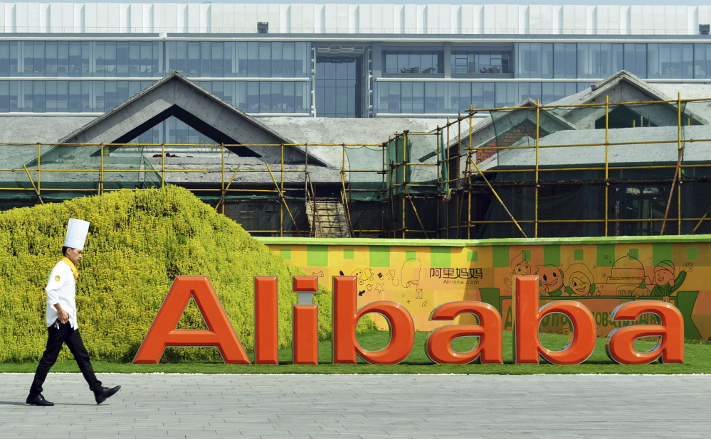 A chef walks on the campus of the Alibaba Group in Hangzhou, China. Alibaba plans to raise up to $25.03 billion – a record for a first-time offering – by selling 368.1 million shares. The $66-$68 price range would give the company a market value exceeding $170 billion. Yahoo owns a 22 percent stake in Alibaba.