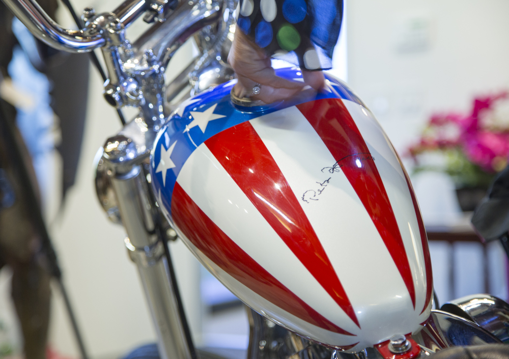This photo shows the autographed gas tank of the Captain America chopper Peter Fonda rode in “Easy Rider” at the Profiles in History auction house in Calabasas, Calif.