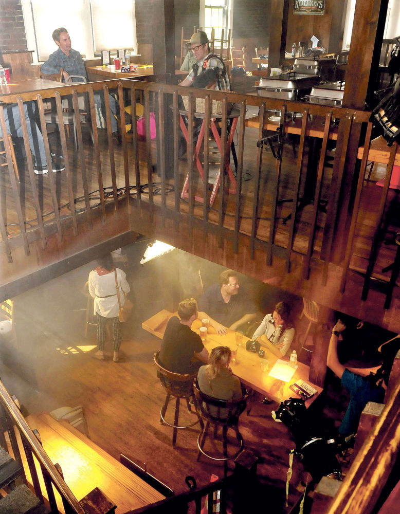 Extras and production staff fill two floors of the Old Mill Pub in Skowhegan before filming promotional commercials for “American Pickers” and “Down East Dickering.”