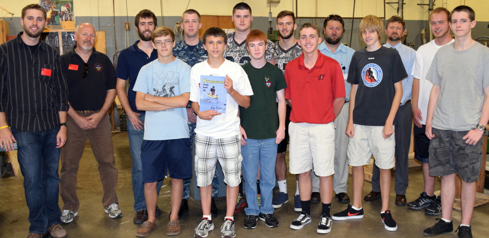 Wells High School kicked off its new Hydrofoils Engineering class with a visit from Portsmouth Naval Shipyard advisers who will partner with students over the next year. Pictured, back row from left, Portsmouth Naval Shipyard workers Trevor Thompson, Rick Cecchetti and Dave Hawk; U.S.S. Scranton crew member Steven Weston; Wells High School students  Kyle Goodale and Ryan Marsh; teachers Jason Hludik and Chrys Demos and student Gavin Turnbull. In front, from left, are students Zack Pierce, Nate Ouellette, Erskine Lothrop, Dan Charpentier, Jake Wilson and David Jacobs.