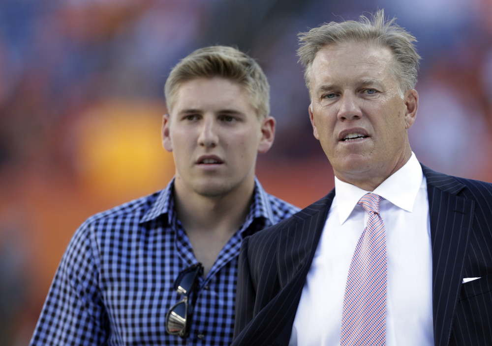 Jack Elway, left, seen with his father at a Denver Broncos game in 2012, pleaded guilty Tuesday to disturbing the peace after being accused of pulling his girlfriend from a car and shoving her to the ground. Elway, who was arrested in May, was sentenced to one year of probation that includes domestic violence counseling.