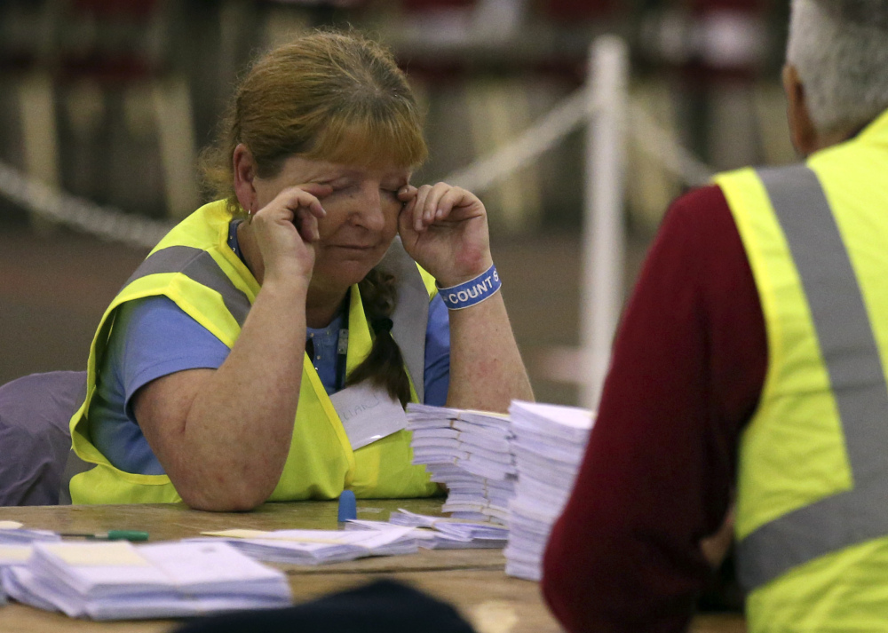 A vote counter in Edinburgh, Scotland, rubs her eyes as the staff counts ballot papers through the night in the Scottish Independence Referendum.