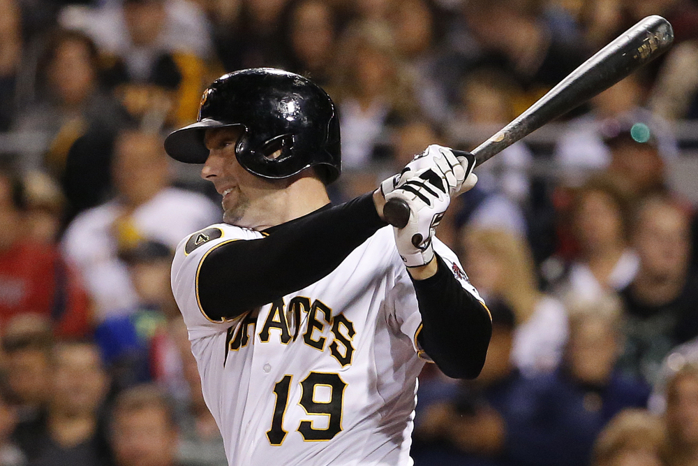 The Pittsburgh Pirates’ Chris Stewart drives in a run with a single off Red Sox starting pitcher Brandon Workman in the fourth inning of Thursday night’s game in Pittsburgh.