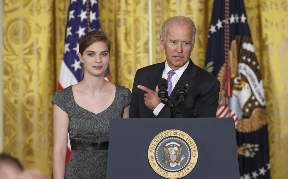 Vice President Joe Biden praises Lilly Jay, who talked about the impact on her life after she was sexually assaulted as a freshman at Amherst College in Massachusetts, as Biden and President Obama unveiled the “It’s On Us” campaign Friday.