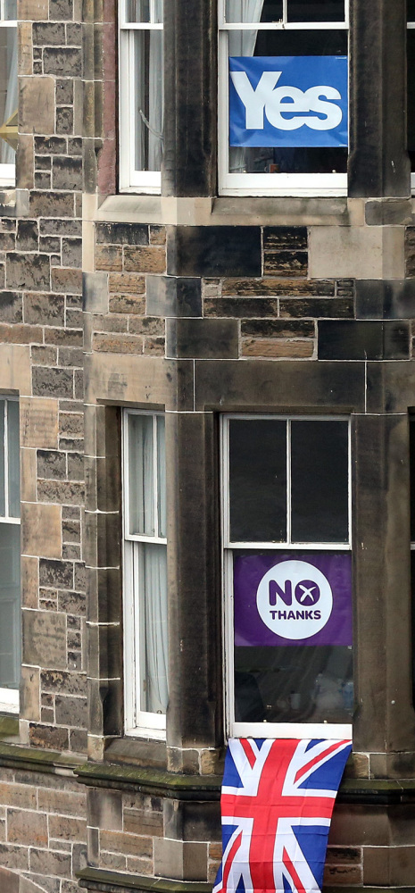 Adjoining apartments display campaign banners in Edinburgh, Scotland. Turnout in the referendum was almost 85 percent.