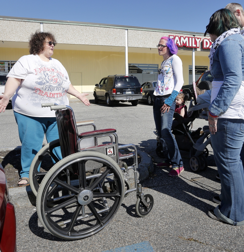 SANFORD, ME - SEPTEMBER 19: Elizabeth Phibeault, left, of Sanford donates a wheelchair to Sarah Saucier for her homeless friend whose wheelchair was stolen on Thursday evening in Sanford. (Photo by Derek Davis/Staff Photographer)