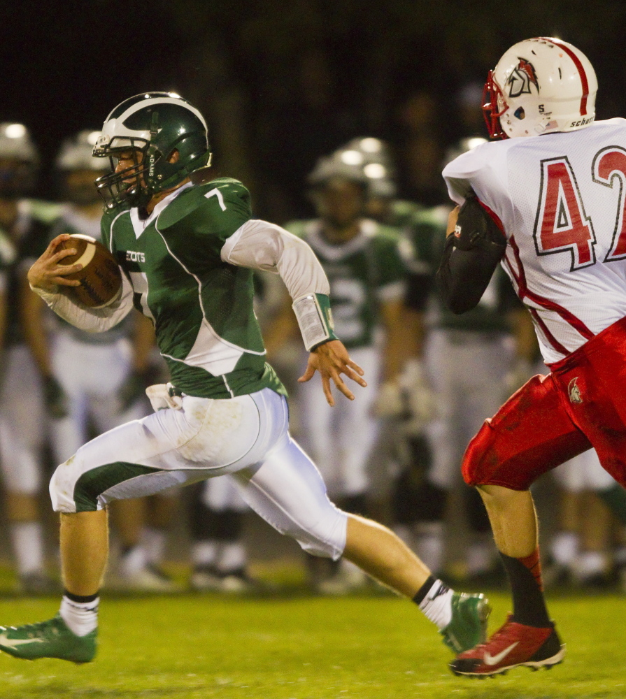 Bonny Eagle quarterback Zach Dubiel breaks free for a big gain while pursued by Sanford’s Eddie Michetti during Bonny Eagle’s 60-12 win Friday night in Standish.