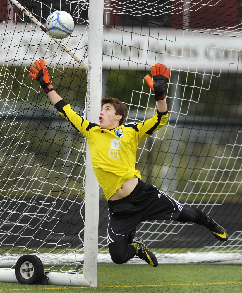 Cheverus keeper Jake Tomkinson deflects a shot off target during an SMAA boys’ soccer game Saturday at Scarborough. Tomkinson finished with eight saves, but Scarborough scored once in each half and improved to 6-0 with a 2-0 victory.