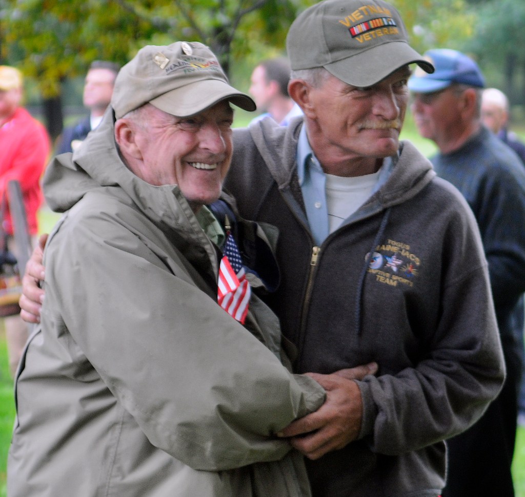 Vietnam veteran David Nevedomsky of Winslow, right, greets fellow veteran Don Taylor of Mount Vernon on Sunday during a ceremony in Capitol Park in Augusta to honor Vietnam vets. Andy Molloy/Kennebec Journal