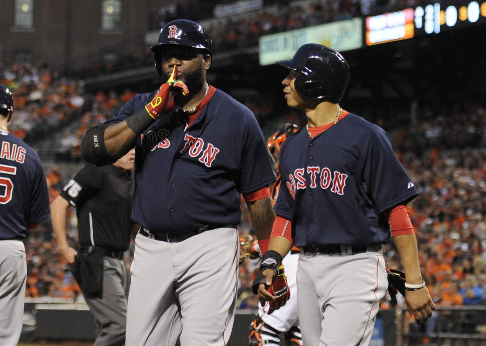 Boston Red Sox designated hitter David Ortiz, left, gestures as he celebrates his two-run home run scoring himself and Mookie Betts, right, in the first inning against the Baltimore Orioles on Saturday in Baltimore. The Associated Press