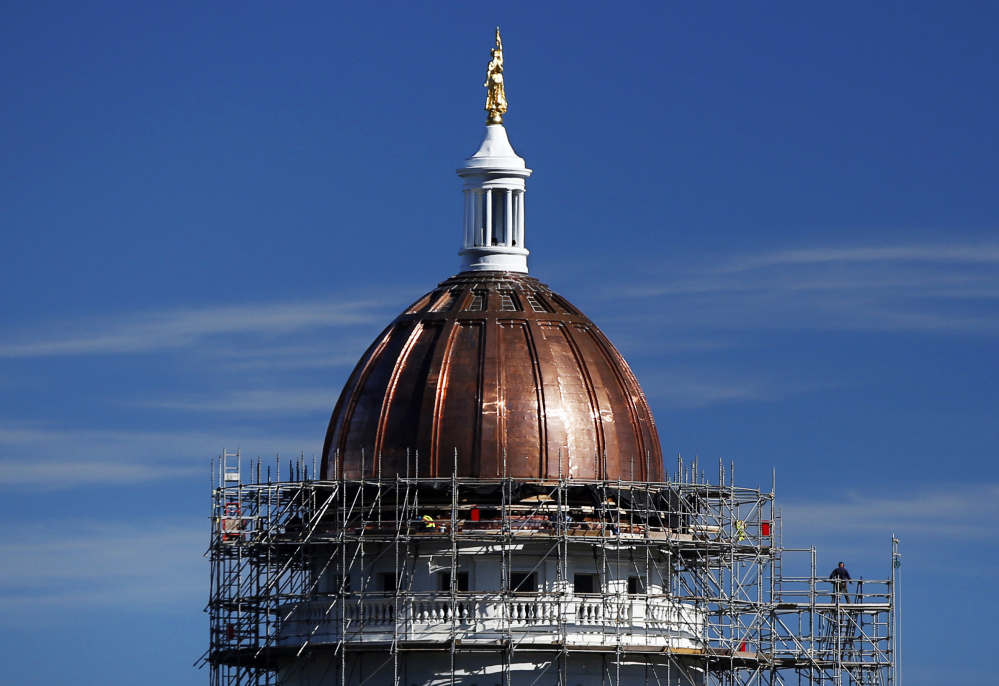 The new copper sheath shines on the State House dome in Augusta. The 100-year-old copper that was removed from the dome may be sold to artists and sculptors to make commemorative pieces or public art.