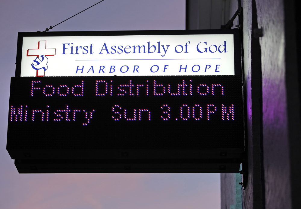 A sign at the First Assembly of God on Cumberland Avenue in Portland calls attention to the church’s Food Distribution Ministry. Members of the small congregation give away up to 10,000 pounds of food each Sunday.