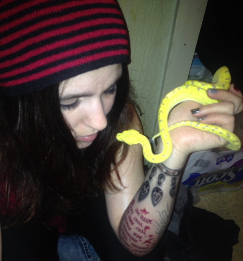 Alicia Herrick handles her pet green tree python Kratos last month.