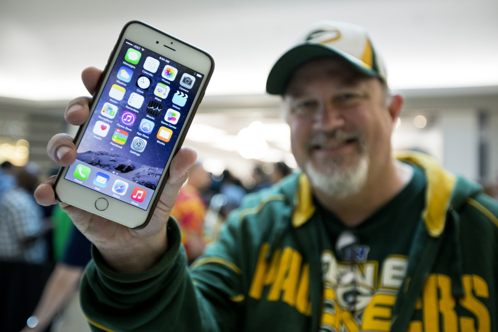 John Mihalkovic of Virginia Beach shows off his newly purchased iPhone 6 Plus. 
The Associated Press