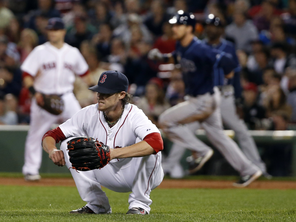 Red Sox starting pitcher Clay Buchholz reacts after giving up a two-run double to the Tampa Bay Rays’ Ben Zobrist, who rounds first base, back right, in the eighth inning Tuesday night at Fenway Park.