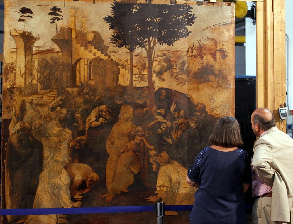People look at one of Leonardo da Vinci’s most famous works, “Adoration of the Magi,” during a press conference in Florence, Italy, Tuesday.