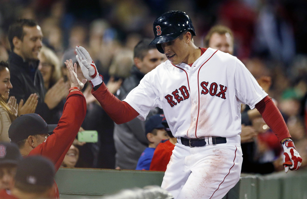 Boston’s Garin Cecchini celebrates his solo home run during the second inning Wednesday night. The home run was his first in the major leagues.